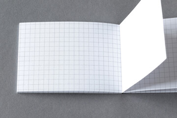 blank plaid opened notebook page on grey background