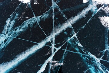 Ice on the Baikal lake. Beautiful cracked ice in winter close-up.