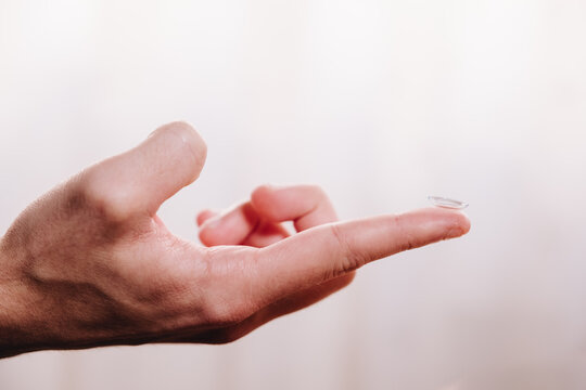Hand holding a contact lens