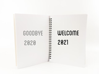 A notebook of written "GOODBYE 2020 WELCOME 2021" isolated with white background.