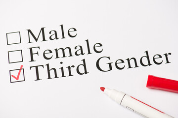 Above photo of red color marker and paper with text male female and third gender isolated on the white background