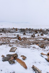 Pyramids of stones in winter on Lake Baikal.