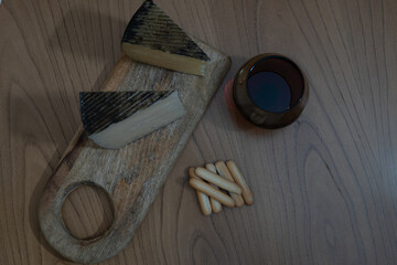 Cheese platter with wine and bread rolls