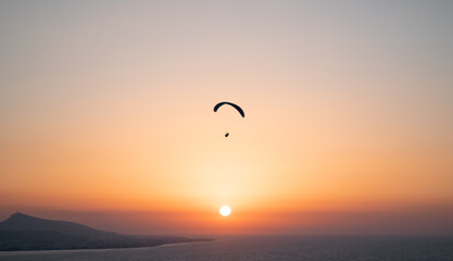 Parachuting - Paragliding in sunset