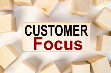 Customer Focus. text on a piece of wood. on a white background