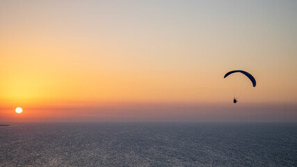 Parachuting - Paragliding in sunset