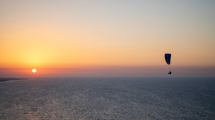 Parachuting - Paragliding in sunset