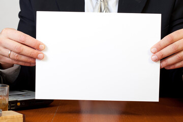 a clean sheet of white paper in male hands