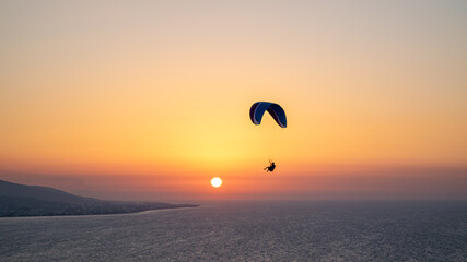 Parachuting - Paragliding in sunset