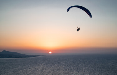 Parachuting - Paragliding in sunset