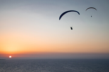 Parachuting - Paragliding in sunset