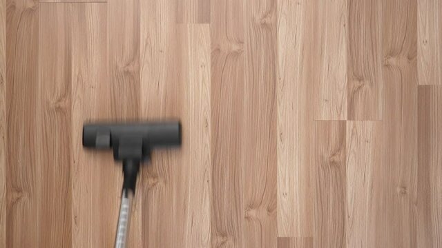 The floor of the laminate is vacuumed with a view from above.