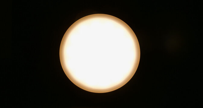 White circle fringed in brown against black background with copyspace