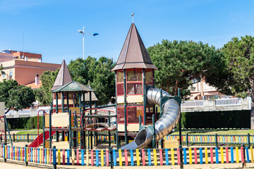 Fototapeta premium Huelva, Spain - May 5, 2020: Empty and closed children playground at sunset due to the alarm state and quarantine in Spain for the epidemic period of deadly COVID-19 coronavirus.