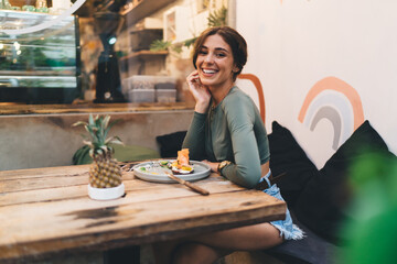Happy woman enjoying lunch in modern cafeteria