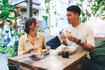 Smiling couple enjoying lunch in outdoor restaurant