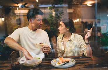 Positive couple having lunch together in restaurant