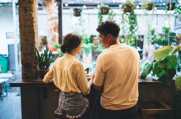 Obraz na płótnie Canvas Young couple talking in modern cafe