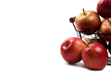 Metal basket of fresh ripe apples isolated on white background