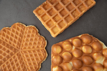 Three different waffles in square, flower and bubble shape.