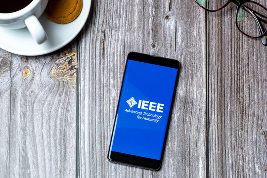 03-10-2021 Portsmouth, Hampshire, UK A Mobile phone or cell phone laid on a wooden table with the IEEE app open on screen