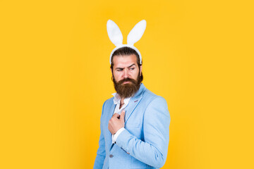 mature bearded male guy looking elegant wearing bunny ears, easter