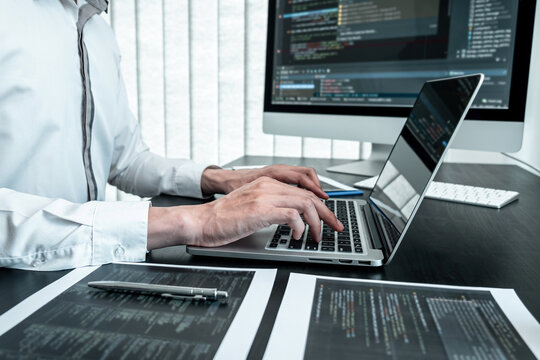 Young Programmer working in software javascript computer in IT office, Writing codes and data code website and coding database technologies to find solution to problem