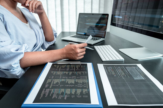 Female Programmer working in software javascript computer in IT office, Writing codes and data code website and coding database technologies to find solution to problem