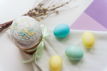 Easter cake, painted eggs and a willow twig on the table. preparation for the holiday.