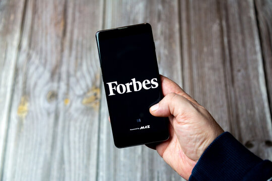 03-10-2021 Portsmouth, Hampshire, UK A Mobile phone or cell phone being held in a hand with the forbes magazine app open on screen