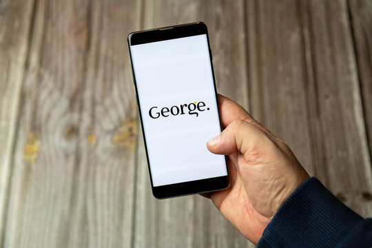 03-10-2021 Portsmouth, Hampshire, UK A Mobile phone or cell phone being held in a hand with the george by asda app open on screen