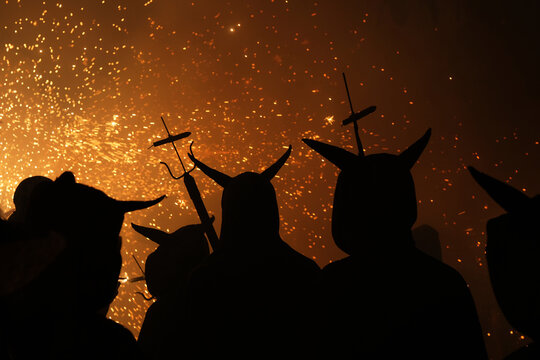 Traditional festival of Catalonia, people dance under the fire and the sound of firecrackers