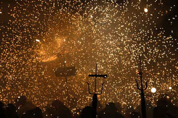 Traditional festival of Catalonia, people dance under the fire and the sound of firecrackers - 419921930