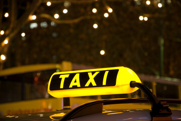 german yellow taxi sign at night with lights