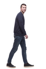 Fototapeta premium young man in jeans striding forward . isolated on a white
