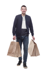young man with shopping bags striding forward