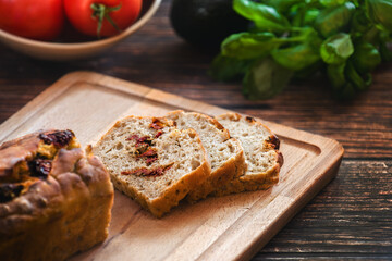 Sliced wheat rye sourdough bread stuffed with sun-dried tomatoes and rosemary.
