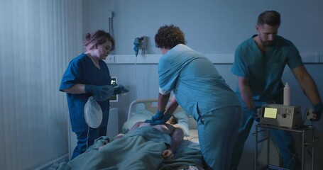 Medical team making cardiopulmonary resuscitation to male patient in hospital