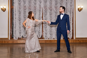 couple dancers before the start of a partner dance in the old hall; dance invitation