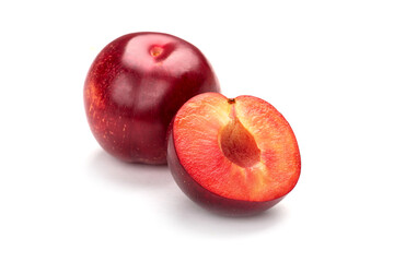 Cut fresh plums isolated on white background.