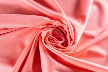 twisted into a spiral fabric of bright pink color for tailoring, background