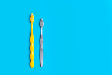 two toothbrushes on a blue background copy the space. the concept of oral hygiene, dental care