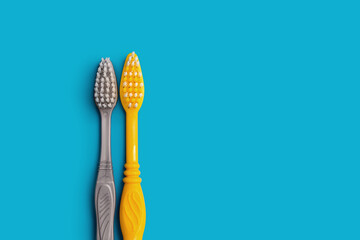 two toothbrushes on a blue background copy the space. the concept of oral hygiene, dental care