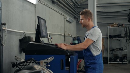 Professional mechanic adjusting automobile wheel alignment car service repair