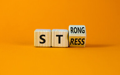 Strong stress symbol. Turned wooden cubes with words 'strong stress'. Beautiful orange background,...