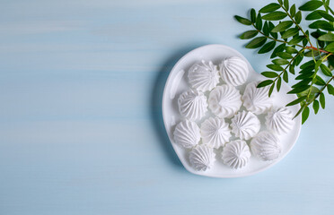 Postcard for the holiday. White chrysanthemum flower on a blue background. Horizontal photo with place for text.