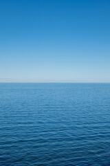 The Baltic Sea on a sunny day with horizon and blue sky.