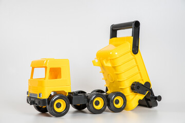 Obraz na płótnie Canvas Plastic car. Toy model isolated on a white background. Yellow truck.