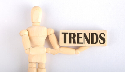 Wooden man shows with a hand to block with text TRENDS