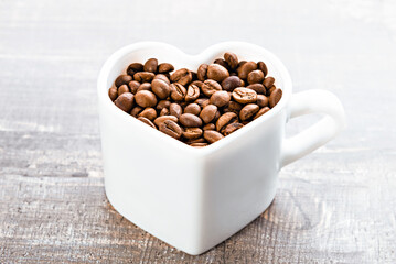 Heart-shaped cup with coffee beans
